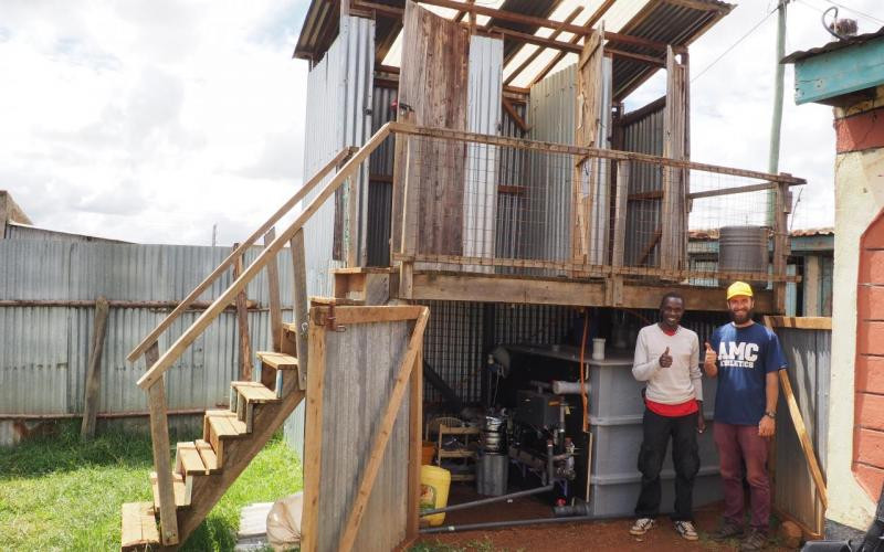 One of our Anaerobic Digestion Pasteurization Latrine (ADPL) prototype (here North unit in Eldoret, Kenya with Aaron and local worker)
